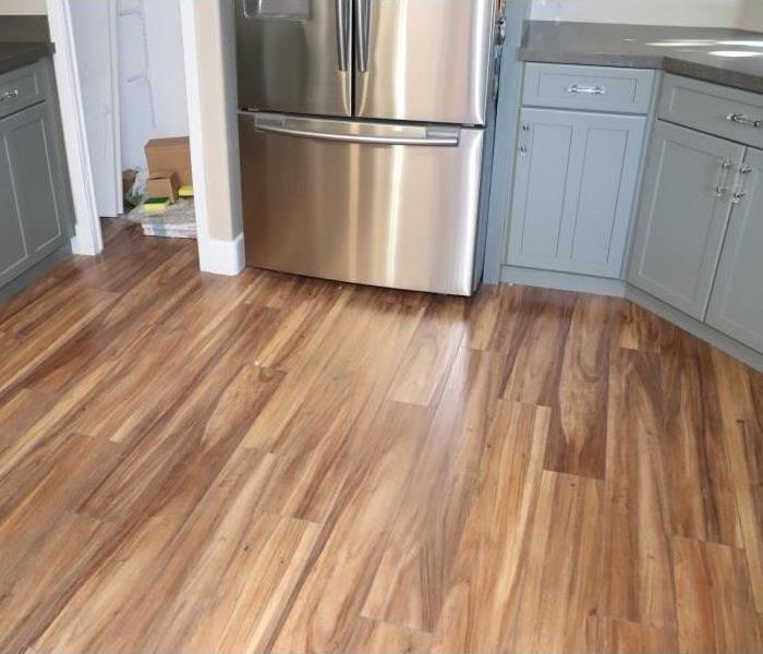 Drywall replaced and new wooden floors added to kitchen.