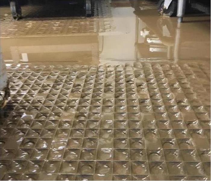 Muddy water flooded cafeteria at a middle school. 