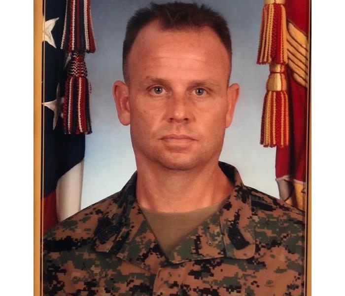 A man dressed in military uniform posing for an official photo. 